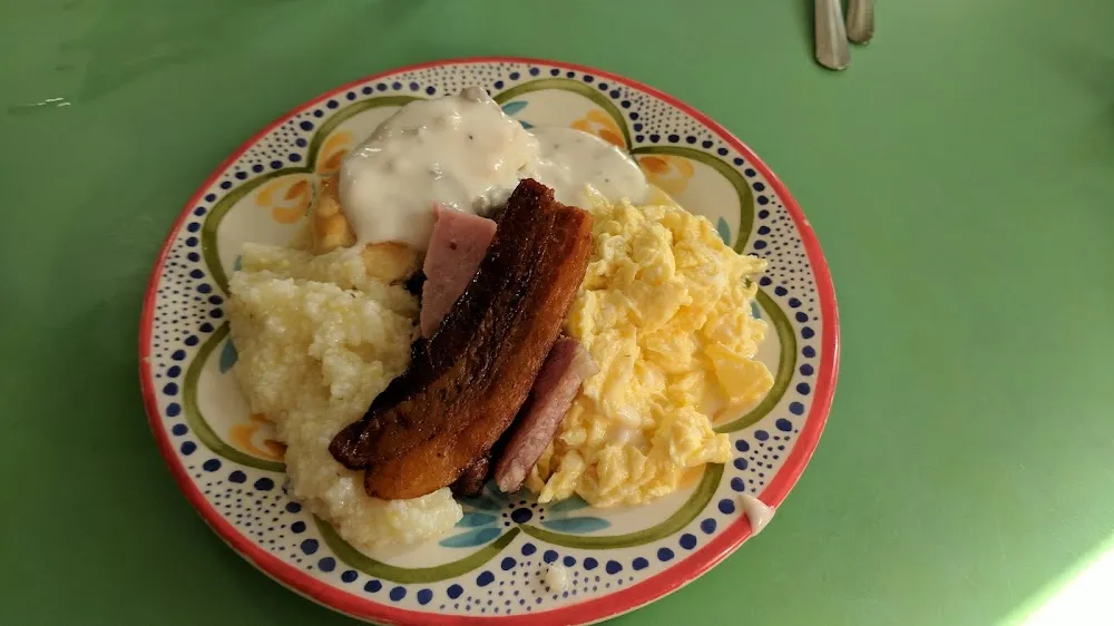 Scrambled Eggs Grits Biscuits and Gravy Bacon and Ham